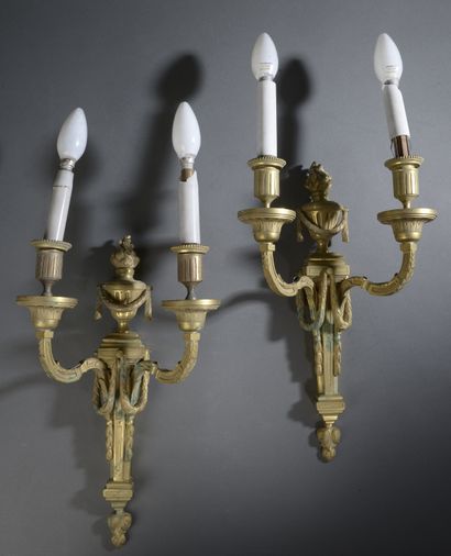 null Pair of chased and gilded bronze wall lights, the shaft holding two arms of...