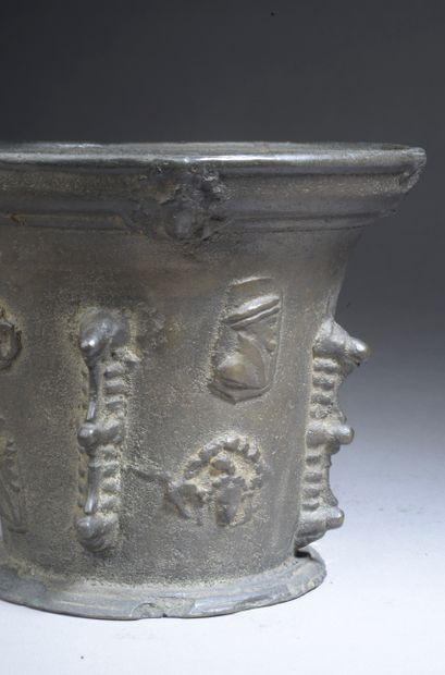 null Bronze mortar with four buttresses and applied patterns of man profiles and...