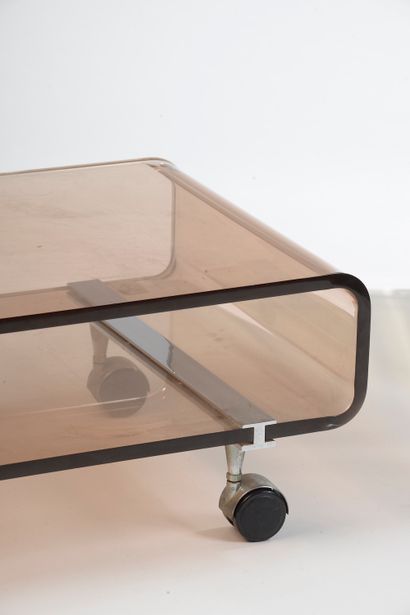 null 
MICHEL DUMAS CREATIONS. 

Low table in smoked thermoformed plastic on wheels....