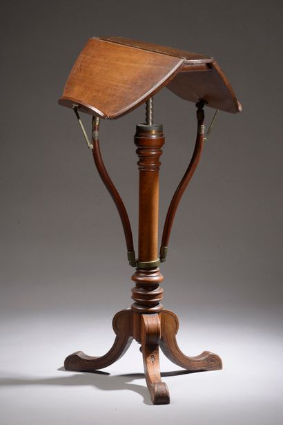 null A mahogany and mahogany veneer target pedestal table with a poly-lobed top resting...