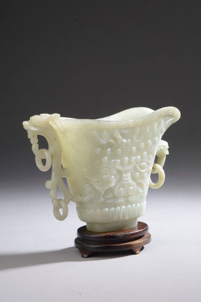 null CHINA - 19th century.

A jadeite coffee pot with flattened carved taotie masks,...