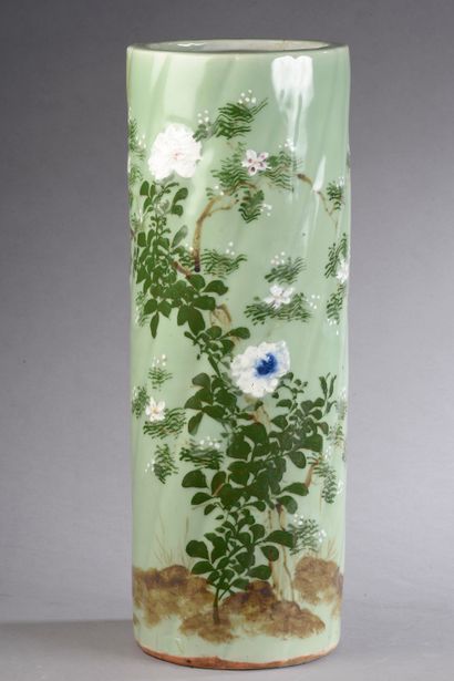 null Porcelain umbrella stand with twisted ribs decorated with flowers on a green...