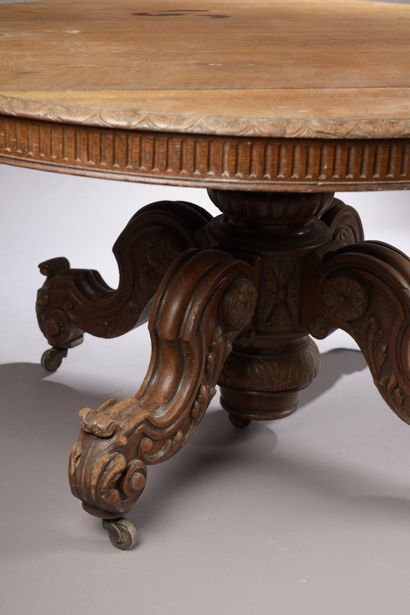 null Circular moulded and carved oak table, the central shaft finished with four...