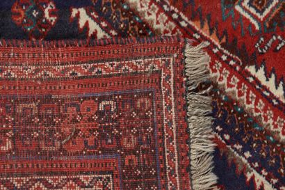 null Wool carpet, the central field decorated with geometric motifs on a red background,...