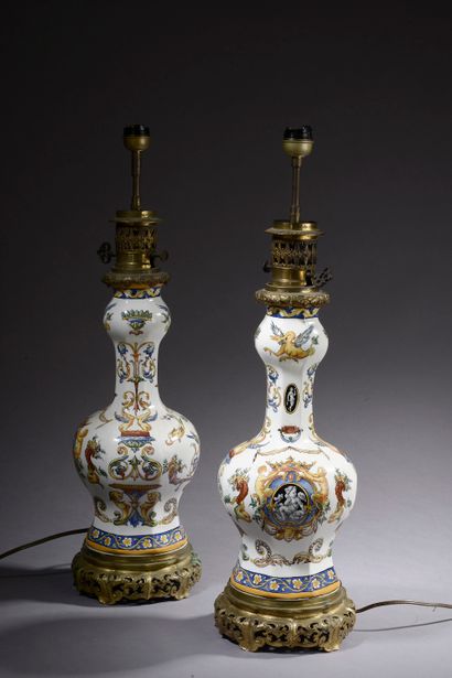 null Pair of earthenware table lamps with polychrome decoration of dolphins and grotesques...