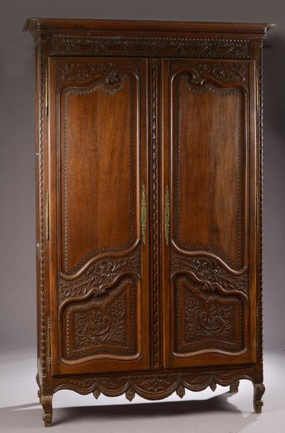 null A large molded and carved natural wood cabinet decorated with flowers, knotted...