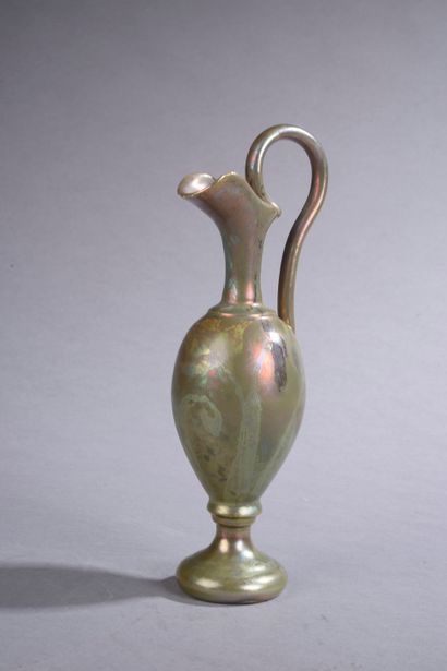 null Attributed to Clément MASSIER.

Iridescent earthenware ewer.

Height : 21,5...
