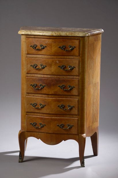 null A rosewood veneered chest of drawers with five drawers, the front of which are...