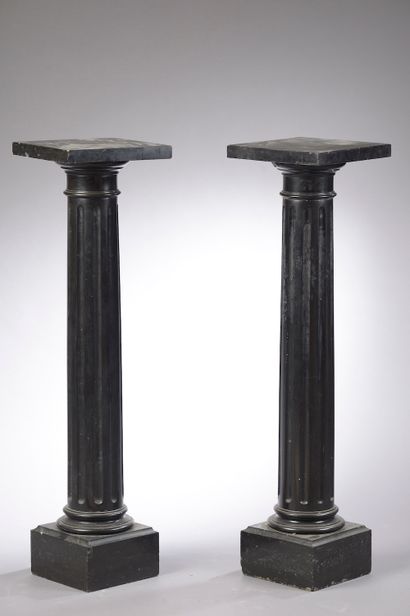 null Pair of black marble columns, the shaft fluted and ringed. The base is square...