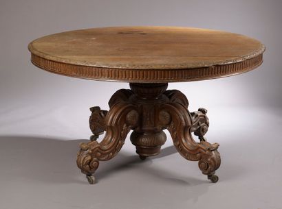 null Circular moulded and carved oak table, the central shaft finished with four...