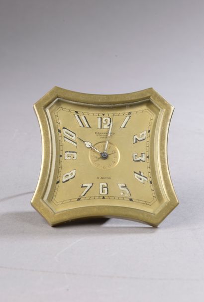 null *Brass alarm clock, concave sides, truncated angles, dial with Arabic numerals,...