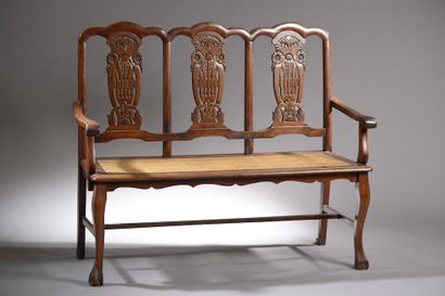 null Moulded and carved wooden bench, the straight back with three openwork designs...