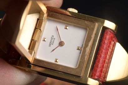null HERMÈS.

Ladies' wristwatch model "Médor" in gilded metal, the square case reveals...