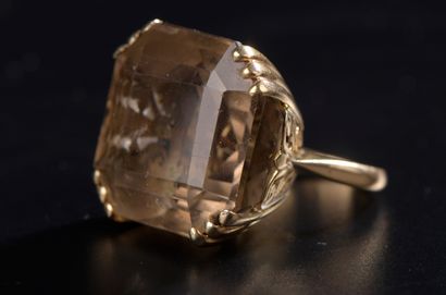 null 18k yellow gold ring set with a large square cut smoky quartz weighing approximately...