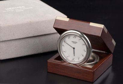 null HERMÈS.

Steel travel clock model "Arceau" the circular case, the white enamelled...