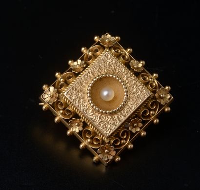 null An 18k yellow gold square brooch bordered with flowers and openwork scrolls,...