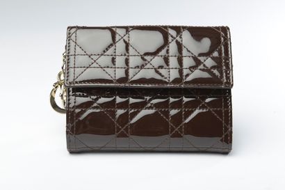 null CHRISTIAN DIOR.

Lady Dior" wallet in chocolate varnished leather holding a...