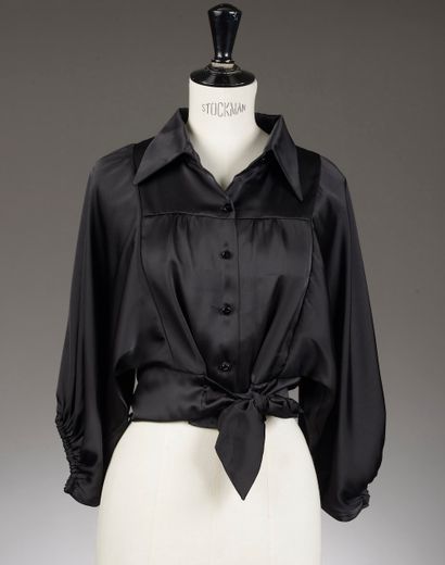 null *Set includes: 

- Black polyester blouse, long bat sleeves, ribbon belt, signed...