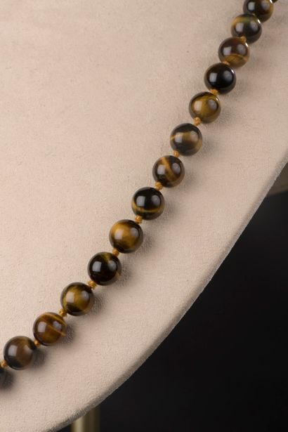 null Necklace of fifty-five pearls in eye of tiger, the clasp in gilded metal.

Length...
