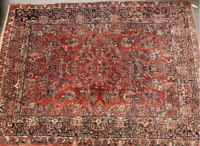 null 
Wool carpet, the central field with polychrome floral decoration on a red background,...