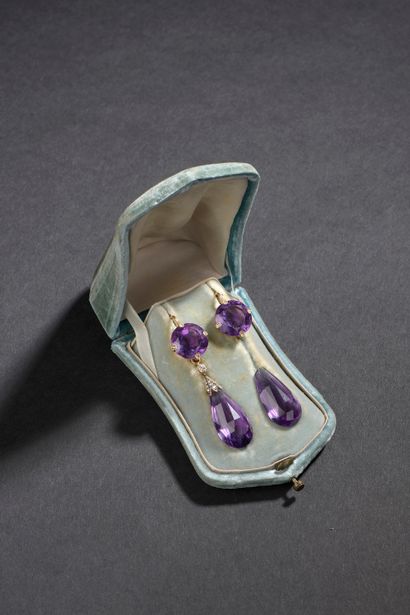 null A pair of earrings, the setting in 18k yellow gold with a round faceted amethyst...