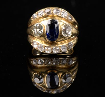 null 18k yellow gold band ring set with an oval faceted sapphire and two old-cut...