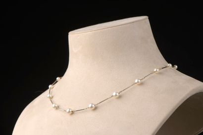 null Necklace in 18k white gold with baton links punctuated by thirteen cultured...