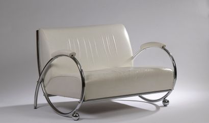 null 
Two seater sofa with chromed tubular structure, the looped armrests in the...