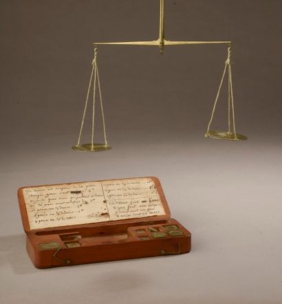 null Brass changer's scale with two plates and weights. Wooden box with handwritten...
