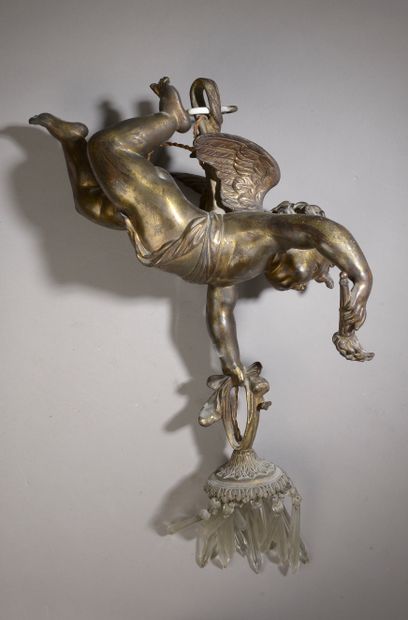 null A gilt bronze chandelier representing a putto holding a glass pendant with a...
