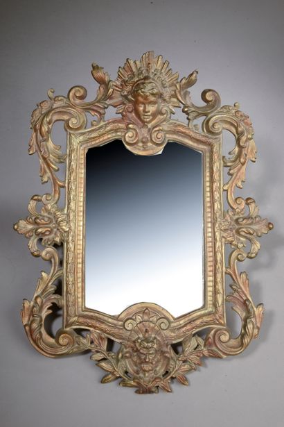 null A gilt bronze mirror decorated with foliage and mascarons. 

Regency style.

Height...