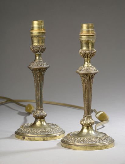null Pair of bronze torches, the fluted shaft with foliage decoration, the circular...