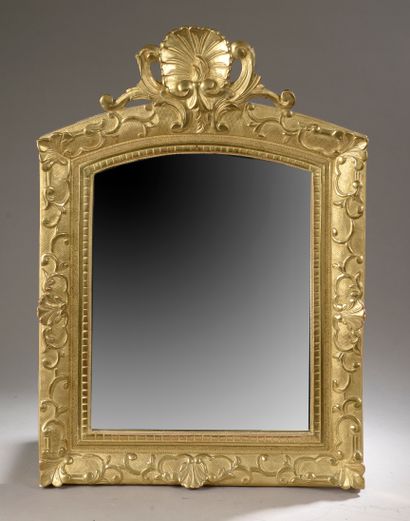 null 
A set of two carved and gilded wood mirrors, one with a shell pediment and...