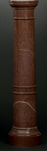 null A large red marble column with a ringed shaft (an accident at the base). 

...