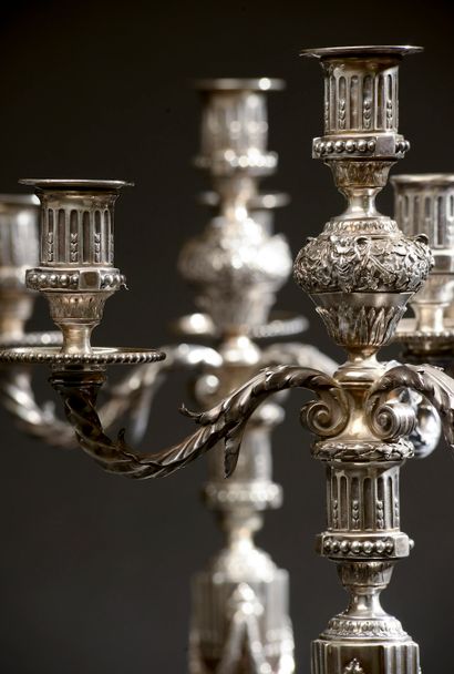 null 
Suite of four large silver candelabras, the shaft with triglyphs and garlands...