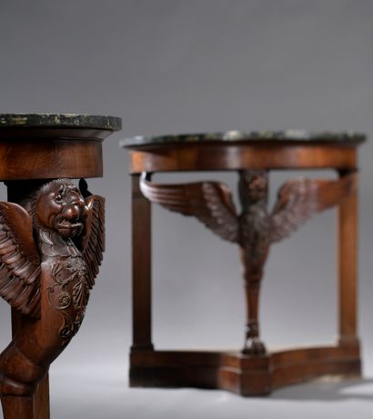  Pair of half-moon consoles in mahogany and stained wood veneer, resting on a winged...