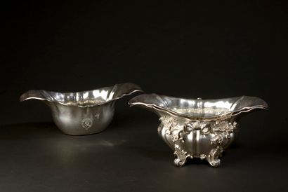 Silver sauceboat resting on four feet, the...
