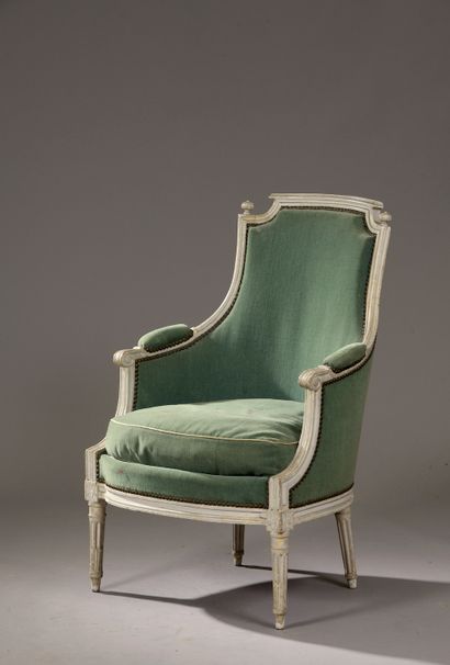 A moulded and white relacquered wood armchair...