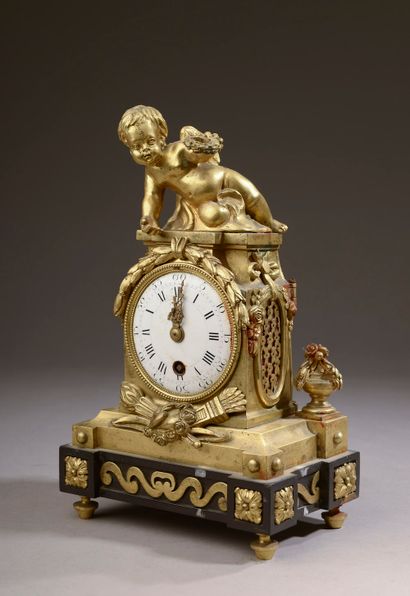  A chased and gilded bronze clock with a victorious Love, the base in black marble,...