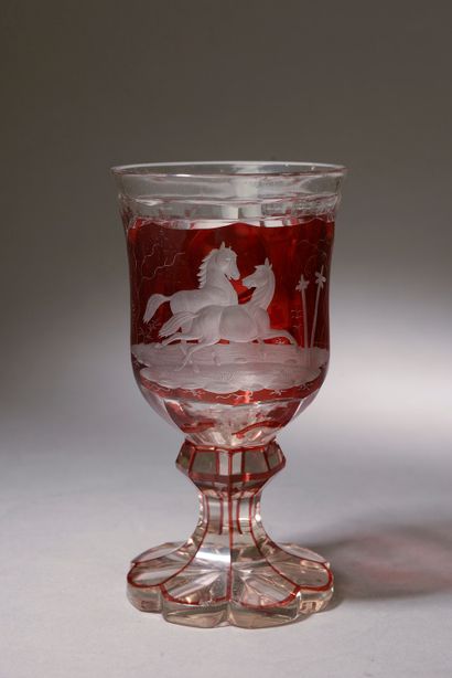 null A Bohemian crystal stemmed glass with engraved horses on a ruby background (small...