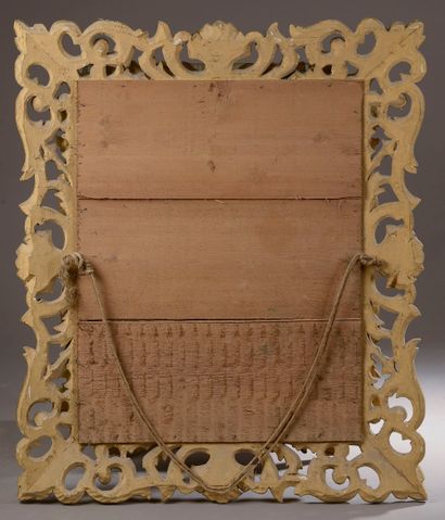 null A rectangular bevelled mirror with inverted profile in carved wood, openwork...