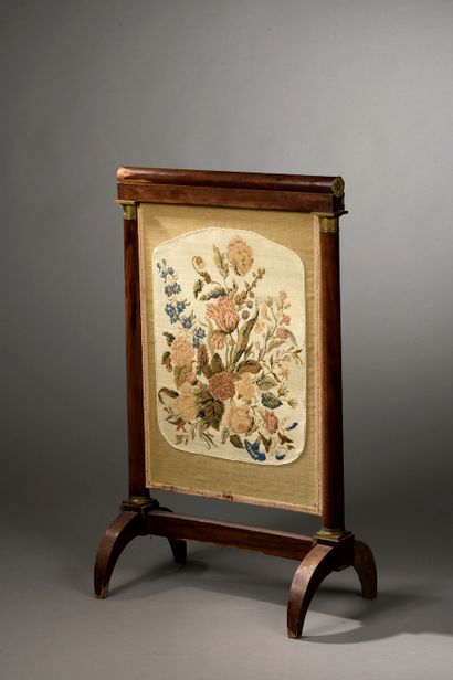 null A mahogany and mahogany veneer fire screen, the leaf embroidered with flowers...