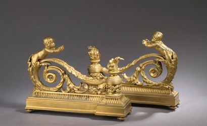 Pair of finely chased and gilded bronze andirons representing a child on an acanthus...