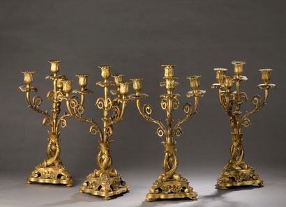  Suite of four chased and gilt bronze candelabras with four lights supported by horns...