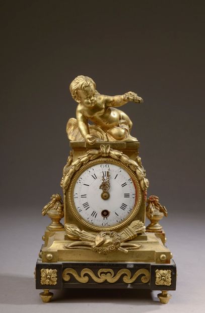 null A chased and gilded bronze clock with a victorious Love, the base in black marble,...
