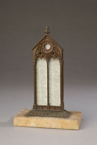 null A patinated bronze and yellow Sienna marble calendar with neo-Gothic decoration,...