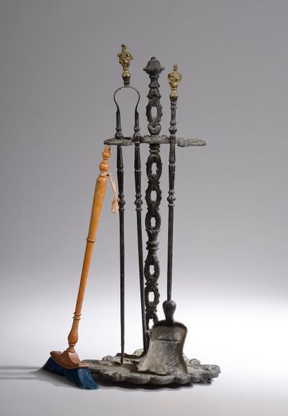  A cast iron hearth set, the bronze handles with a rocaille decoration composed of...
