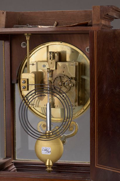  A mahogany, mahogany veneer and light wood fillet cage clock with a large round...