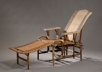 null Rattan long chair decorated with a green and red frieze with its footrest, the...