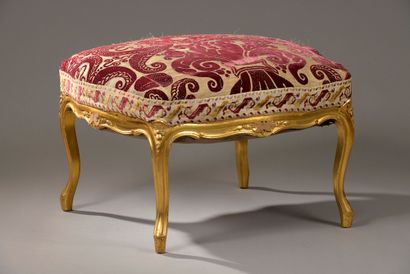 null A large square stool in moulded, carved and gilded wood, the belt decorated...